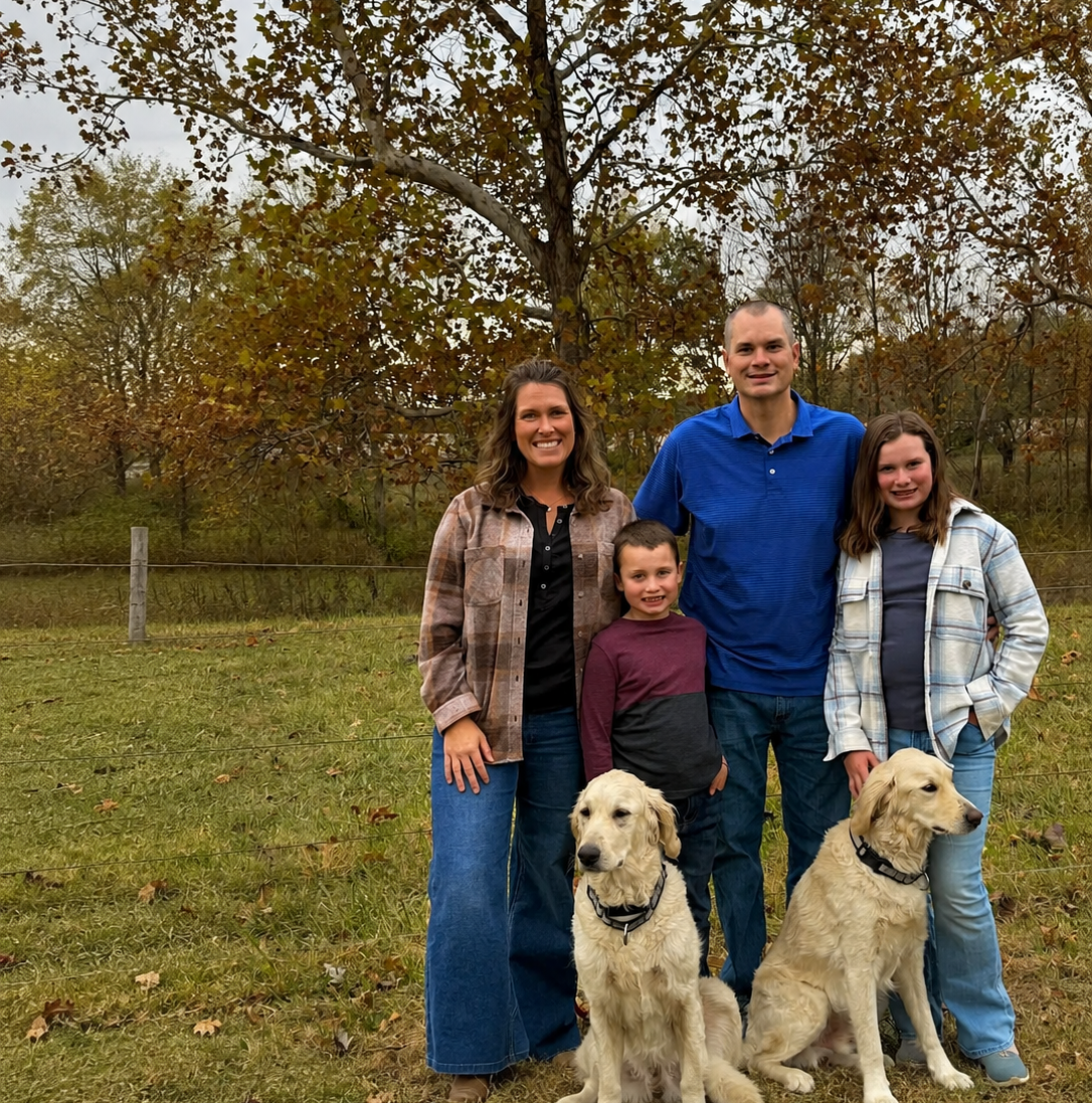 The Spry family with their two golden retrievers